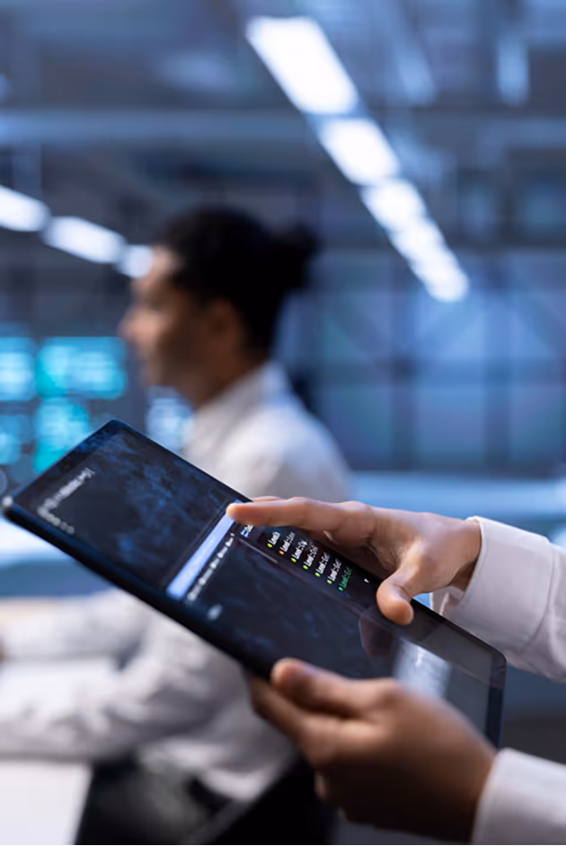 Person using a tablet in an operations workspace.